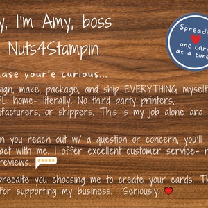 May include: A wooden background with white text and a blue circular logo that says "Spreading one card at a time!". The text says "Hey, I'm Amy, boss @ Nuts4Stampin".