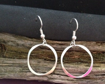 Round forged dangle silver earring.