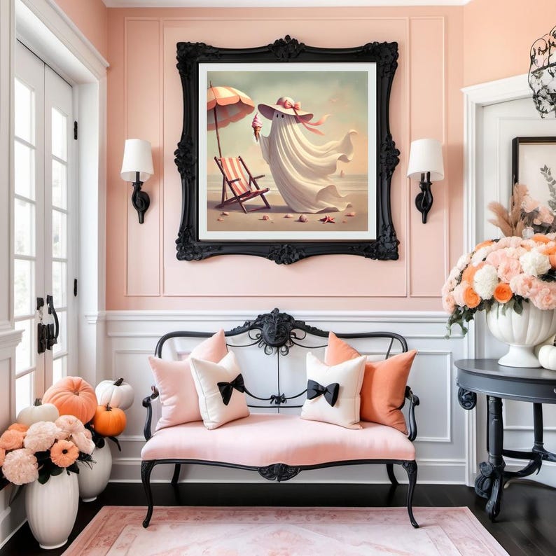 May include: A whimsical interior scene featuring a framed artwork of a ghost at the beach, a pink loveseat with pillows, and decorative pumpkins and flowers. The artwork is framed in a black ornate frame.