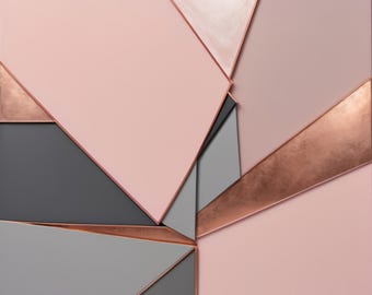 May include: A square wall art piece featuring a geometric composition of angular panels in shades of dusty pink, charcoal gray, and a single pearlescent white section, all separated by thin, metallic copper-colored dividers and edges.