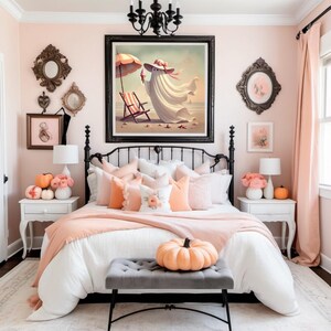 May include: A bedroom with a black wrought iron bed frame, adorned with peach and white bedding and pillows. A large framed artwork depicts a ghost on a beach. The room is decorated in shades of peach and white, with pumpkins and floral accents.