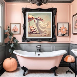 May include: A whimsical bathroom scene featuring a pink clawfoot bathtub, framed artwork, and decorative pumpkins. The artwork depicts a ghost at the beach. The walls are painted in pink and gray tones, creating a playful and inviting atmosphere.