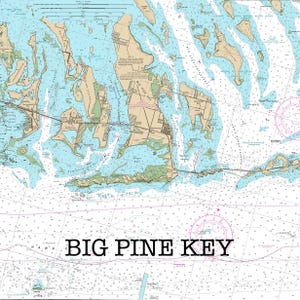 May include: A nautical chart of Big Pine Key, Florida, featuring landmasses in tan and green, surrounded by light blue water. The chart includes detailed markings and the text "BIG PINE KEY" in a bold, black font.