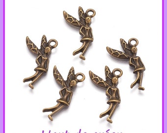 May include: Five antique gold-toned metal charms shaped like fairies with wings. Each charm has a loop at the top for attaching to a necklace, bracelet, or other jewelry.
