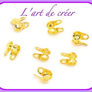 Puede incluir: Siete cuentas de crimpado de metal dorado para la elaboración de joyas. Las cuentas son redondas y tienen un pequeño agujero en el centro.