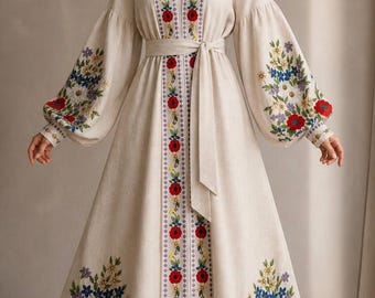 May include: A cream-colored, long-sleeved dress with floral embroidery. The dress features a V-neck, a waist tie, and intricate floral patterns in red, blue, and purple. The sleeves are long and puffy, and the dress has a floor-length skirt.