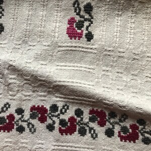 Peut inclure: Tissu blanc avec une texture tiss&eacute;e et un motif floral brod&eacute; dans des tons de bordeaux et de gris.
