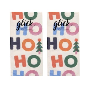 May include: Two rectangular paper napkins featuring a repeating Ho Ho Ho pattern in various colours including red, green, blue, and pink. Each napkin includes a small graphic of a Christmas tree and the text Glick Luxury Accessories printed.