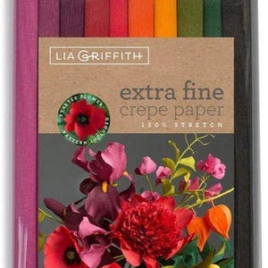 May include: A pack of extra fine crepe paper rolls in shades of pink, purple, red, orange, green, and black. The packaging displays a floral design and the text "extra fine crepe paper". The pack contains 10 rolls, each 25cm x 200cm.