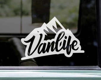 May include: White vinyl decal with a mountain range design and the word "Vanlife" in a stylized font.