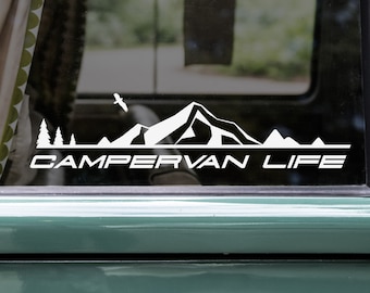 May include: White vinyl decal with a mountain range silhouette and the text "CAMPERVAN LIFE" on a green car window.