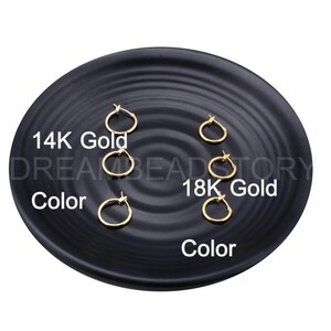 May include: Five gold hoop earrings on a black plate. The earrings are arranged in two rows, with the top row labeled "14K Gold" and the bottom row labeled "18K Gold".