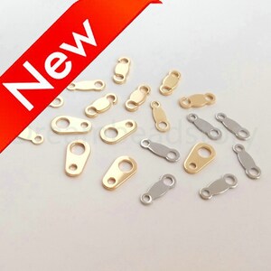 May include: A collection of gold and silver metal jump rings. The jump rings are oval shaped with two small loops on each side. The jump rings are used for jewelry making.