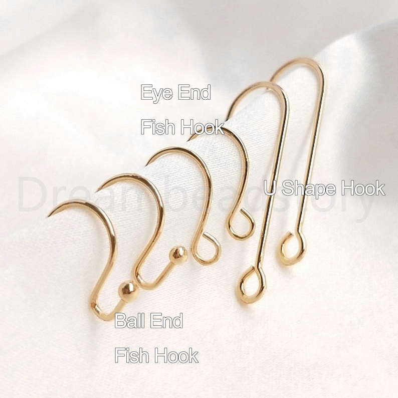 May include: Five gold earring hooks, including a U-shape hook, two fish hooks, an eye end hook, and a ball end hook.