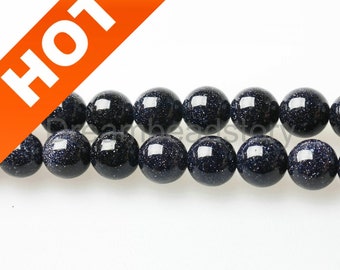 May include: A strand of dark blue gemstone beads with a speckled texture. The beads are round and uniform in size.