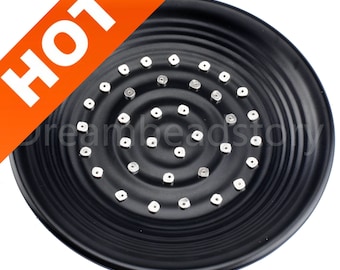 May include: Black round shower head with a circular pattern of small silver square nozzles.