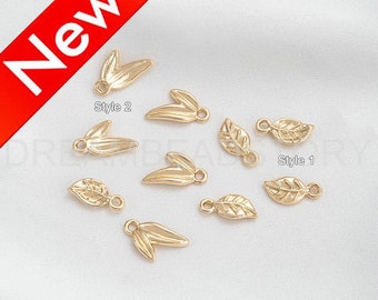 May include: Gold leaf charms in two styles. Style 1 is a simple leaf shape. Style 2 is a double leaf shape.