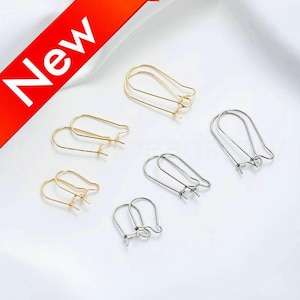 May include: A set of six earring findings, three gold and three silver, in a variety of shapes and sizes. The findings are all made of metal and are designed to be used with earrings.