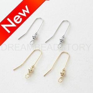 May include: Two pairs of earring hooks with a small ball at the end. One pair is silver and the other is gold.