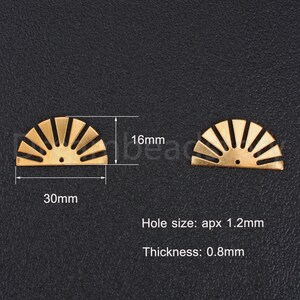 May include: Two gold metal sunburst half-circle charms with a hole in the center. The charms are 30mm wide and 16mm tall. The hole size is approximately 1.2mm and the thickness is 0.8mm.