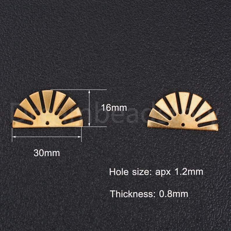 May include: Two gold metal sunburst half-circle charms with a hole in the center. The charms are 30mm wide and 16mm tall. The hole size is approximately 1.2mm and the thickness is 0.8mm.