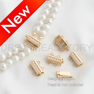 May include: Gold-colored jewelry clasps with clear rhinestones are displayed. The clasps are rectangular with multiple loops for attaching to jewelry. The image also shows a double strand of white pearls. Text in the image reads "New" and "Usage Example Pearl is Not Included."