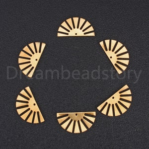 May include: Six gold metal half-circle shapes with a sunburst design. Each shape has a small hole at the top.