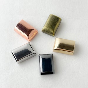 May include: Five metal rectangular slider buckles in different finishes: gold, silver, black, copper, and antique brass.