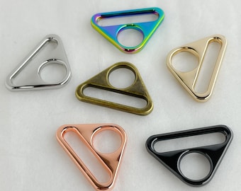 May include: Five triangle-shaped metal slider buckles in different colors: silver, iridescent, gold, rose gold, and black.