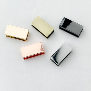May include: Five metal rectangular slider buckles in different finishes: gold, silver, black, rose gold, and antique brass.