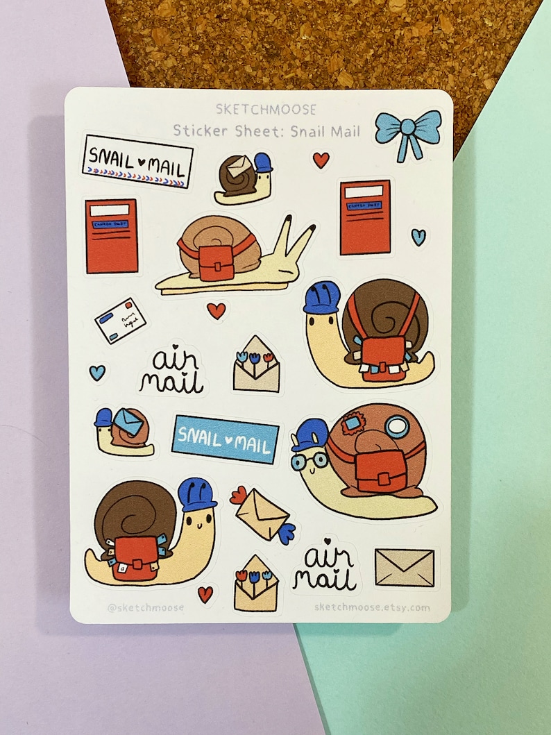 May include: A sticker sheet featuring snail mail themed illustrations. The sheet includes snails carrying mailbags, mailboxes, envelopes, and the text "Snail Mail" and "Air Mail".