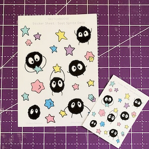 May include: Two white sticker sheets with black Soot Sprite characters and pastel-coloured stars. The text "SKETCHMOOSE Sticker Sheet: Soot Sprite Deco" is printed on the sheets.