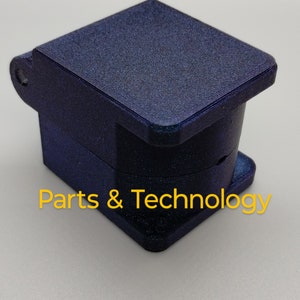May include: A dark blue, square-shaped box with a hinged lid. The box is made of a textured material and has a subtle sparkle. The text "Parts & Technology" is printed on the bottom of the box.
