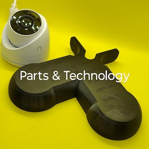 May include: A white dome security camera positioned next to a black, 3D-printed mounting bracket with a distinct Y-shaped design. The black bracket features the white text Parts & Technology printed across its flat, textured surface.