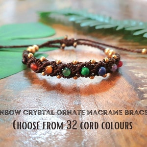 May include: A brown macrame bracelet with rainbow crystal beads and gold beads.  "Rainbow Crystal Ornate Macrame Bracelet Choose From 32 Cord Colours"