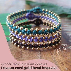 May include: A close-up of a multi-colored cord bracelet with gold beads. The bracelet is made with teal, purple, and brown cords.  "Choose from 28 vibrant colours" and "Custom cord gold bead bracelet" are written in the image.