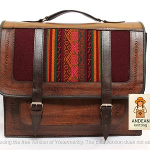 May include: A brown leather satchel with a woven textile panel featuring a geometric design in red, orange, green, and yellow. The bag has a top handle, two buckle straps, and the "ANDEAN knitting" logo.
