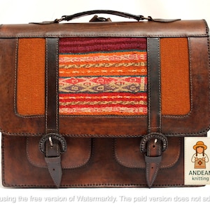 May include: A brown leather satchel with a woven textile panel in the center, featuring orange, red, and cream colors. The bag has two front pockets, buckle closures, and a top handle. The label says "ANDEAN knitting".