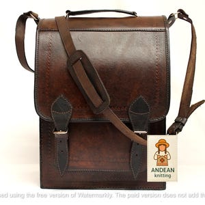 May include: A brown leather satchel with a flap closure and adjustable shoulder strap. The bag features a top handle, decorative stitching, and two buckle closures. The bag has a tag that says "ANDEAN knitting".