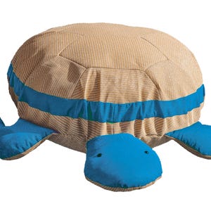 May include: A large, plush turtle-shaped cushion. The shell is tan with a striped pattern, with a wide blue stripe. The head and flippers are a vibrant blue, with small black eyes.
