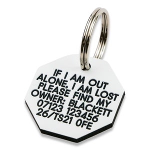 May include: White octagonal pet ID tag with black text that reads "IF I AM OUT ALONE, I AM LOST PLEASE FIND MY OWNER: BLACKETT 07123 123456 26/TS21 OFE". The tag has a silver metal ring attached.