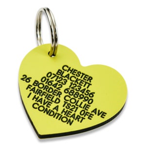 May include: Yellow heart-shaped dog tag with black text. The text reads: Chester Blackett 07123 123456 26 Border Collie Ave Fairfield TS21 OFE 01642 688990 I Have A Heart Condition.