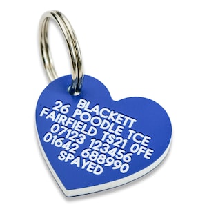 May include: Blue heart-shaped dog tag with white text that reads "26 POODLE TCE BLACKETT FAIRFIELD TS21 0FE 07123 123456 01642 688990 SPAYED"