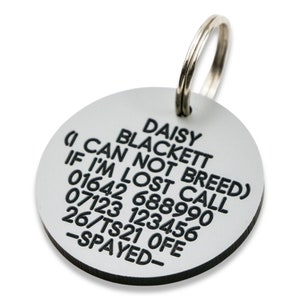 May include: Silver dog tag with black text that reads "DAISY BLACKETT (I CAN NOT BREED) IF I'M LOST CALL 01642 688990 07123 123456 26/TS21 OFE -SPAYED- "