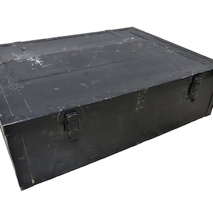 May include: A black metal storage box with two latches and a worn, distressed finish.