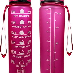 May include: Pink motivational water bottle with a black lid and carrying strap. The bottle has time markers and motivational quotes printed on it. The bottle has a capacity of 32 ounces (900 ml).
