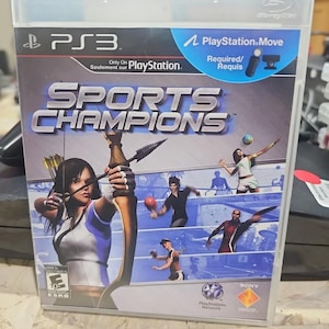 May include: A PlayStation 3 game case for "Sports Champions." The cover art features a woman aiming a bow and arrow, along with other athletes. The game requires PlayStation Move.