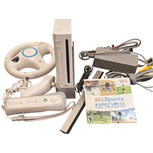 May include: A white Nintendo Wii console with a matching remote, sensor bar, and steering wheel. Includes a power adapter, cables, and the Wii Sports game disc. The console and accessories are white with blue accents.