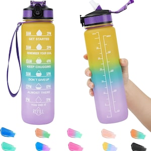 May include: A motivational water bottle with a rainbow gradient design. The bottle has a purple lid and a straw. The bottle has time markings and motivational quotes on the side. The bottle is 32 ounces.