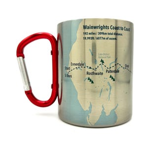 May include: A stainless steel travel mug with a red carabiner handle. The mug features a map of the Wainwright Coast to Coast trail in England, with the text "Wainwrights Coast to Coast 192 miles / 309km total distance. 19,993ft / 6077m of ascent." The map shows the trail route and highlights key locations like Ennerdale, Rosthwaite, and Patterdale.